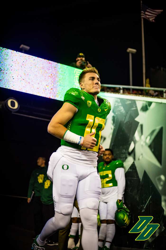 Oregon Ducks quarterback Bo Nix runs out of the tunnel during senior night ceremonies at Autzen Stadium.
